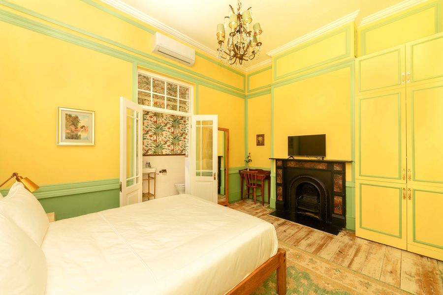 A fireplace and a smart TV in the yellow room