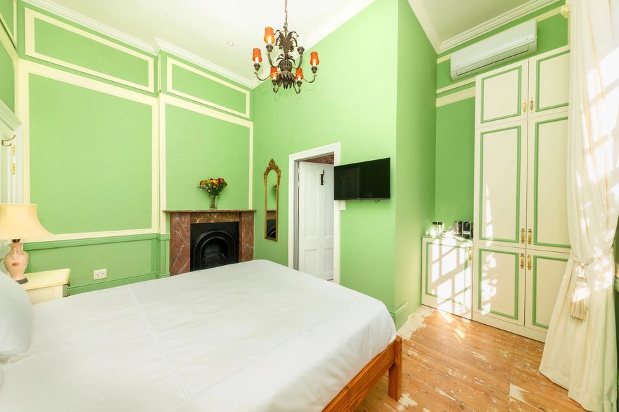 The green room from the doorway, its fireplace and wardrobe