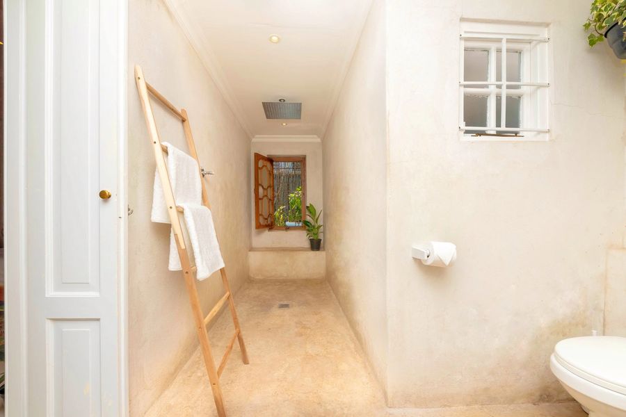 The stone-finish bathroom and walk-in shower