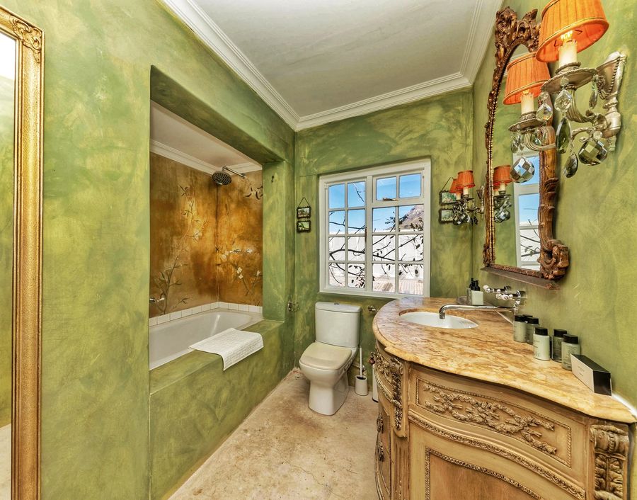 The bespoke bathroom with a carved vanity and a bath