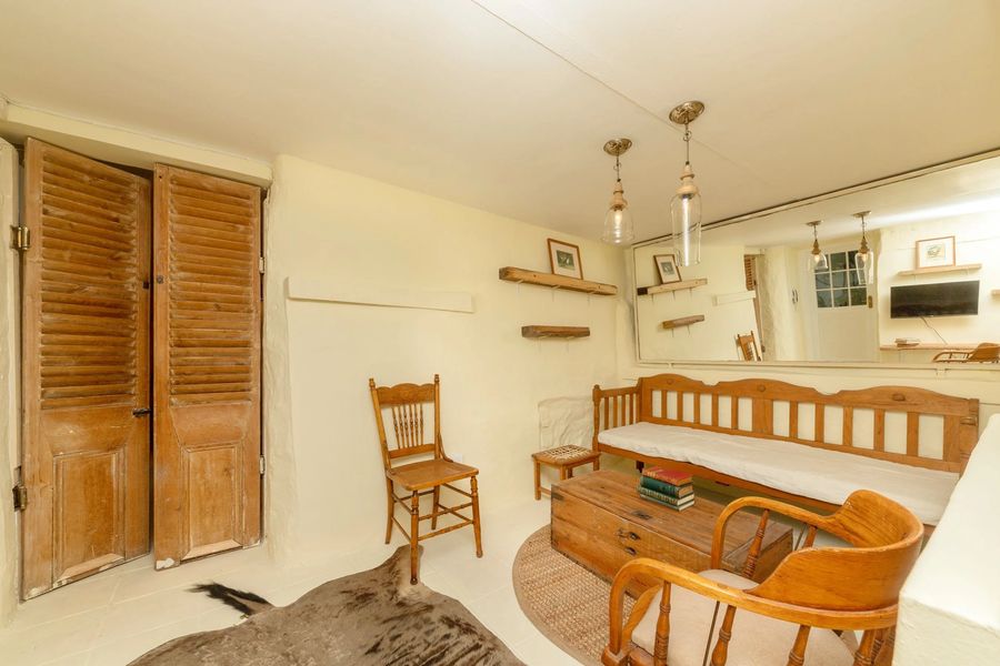 The living room with timber chairs and a wooden bench